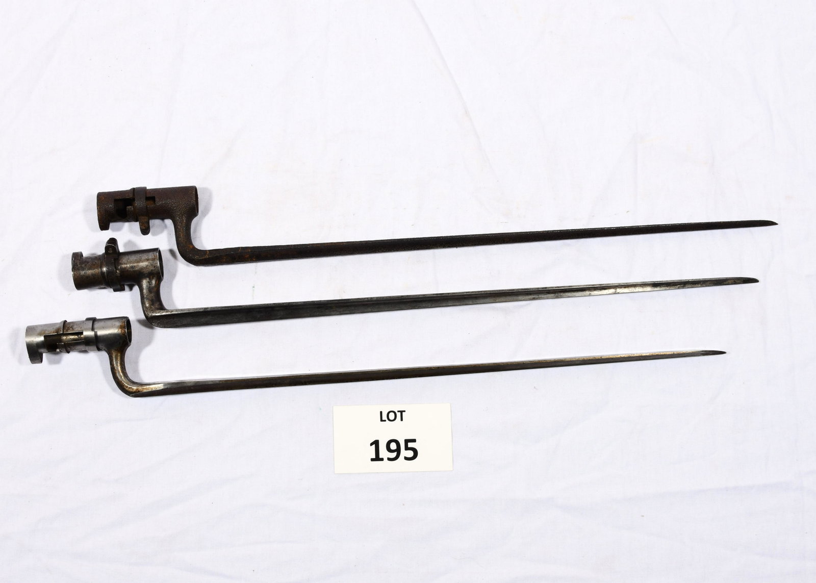 Lot of Bayonets: A lot of 3 bayonets. One is marked "US". All 3 are 21" long. *notes- all have rusting and wear. The one marked "US" has a loose piece at the end.