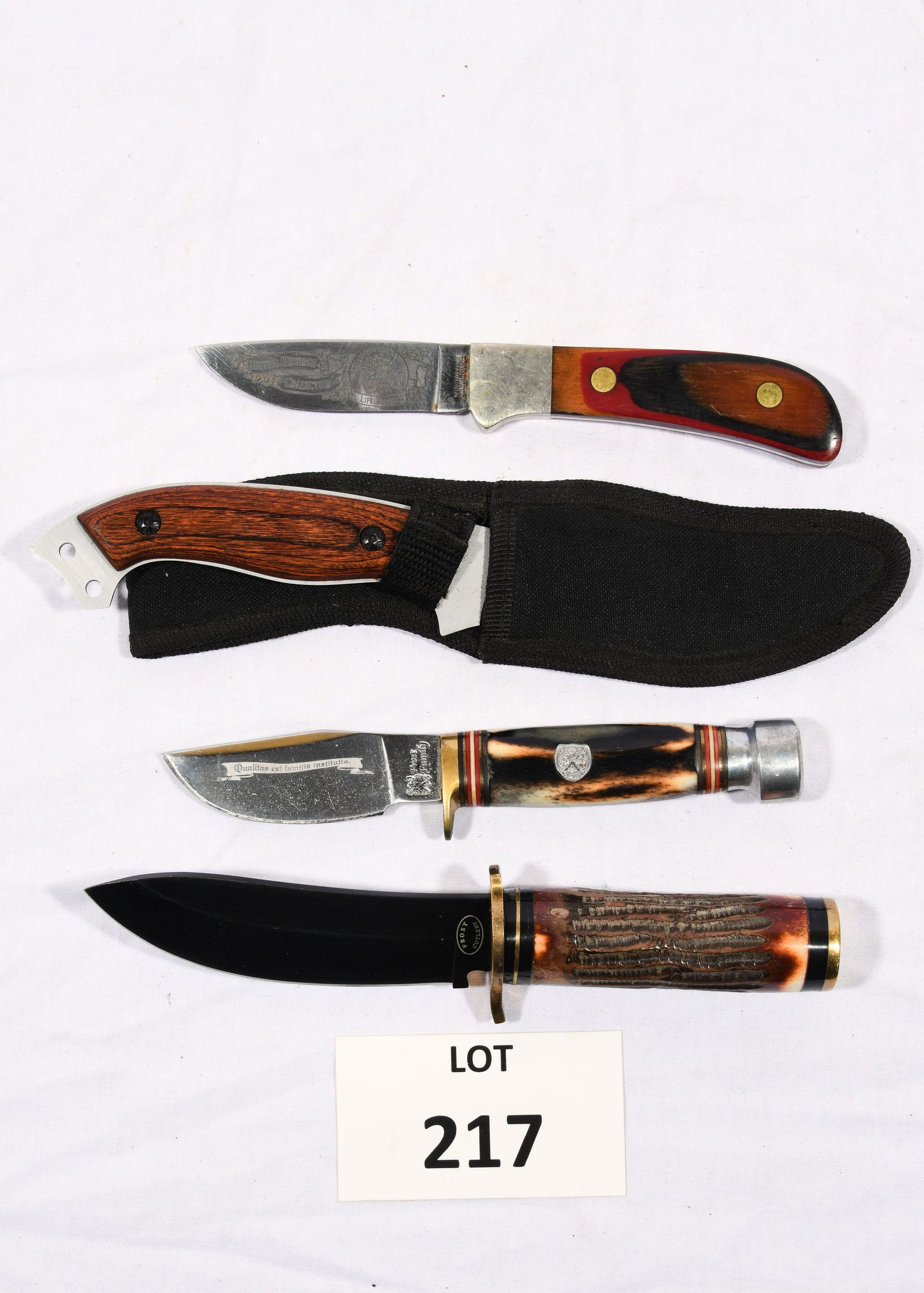 Lot of Knives Including Frost Cutlery and Winchester: A lot of 4 knives including a Winchester knife from the Hunting Heritage Collection for the North American Hunting Club. Blade is marked with clubs logo and has a wood grip. The other 3 knives are mad