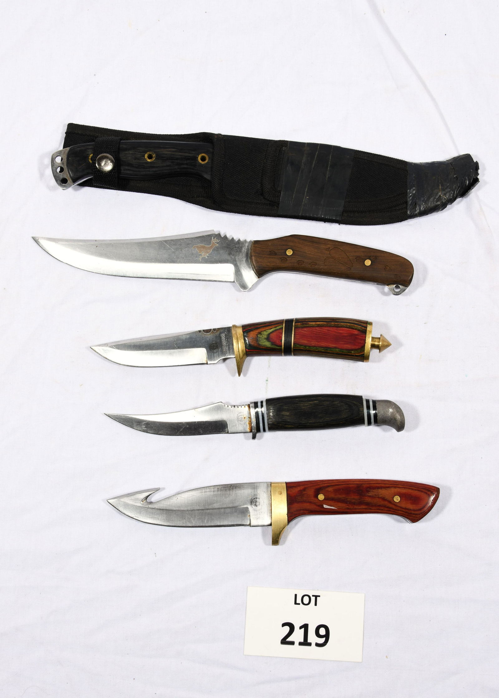 Collection of Chipaway Knives: A group of 5 Chipaway branded knives. All have decorative grips/handles. Longest knife is 12 1/2" long and comes with a black sheath. *notes- sheath has been taped. General wear from use and age throu