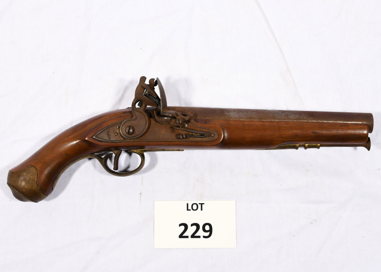 Replica of a Tower Flintlock Pistol: A replica of a Tower flintlock pistol. Possibly made in Japan but not marked. .69 cal. Surface rust covering barrel and lock, brass ports. Has a dark patina. 15 1/2" long.