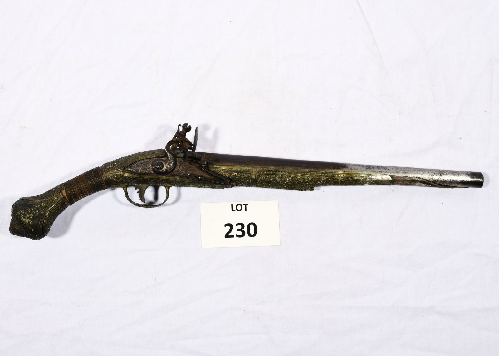 19th Century Ottoman Flintlock Pistol: A 19th century Ottoman Flintlock pistol with embossed silver clad stock. Approximately 60 cal. This pistol was made between 1800 and 1820. The stock is covered with heavily worked embossed silver shee