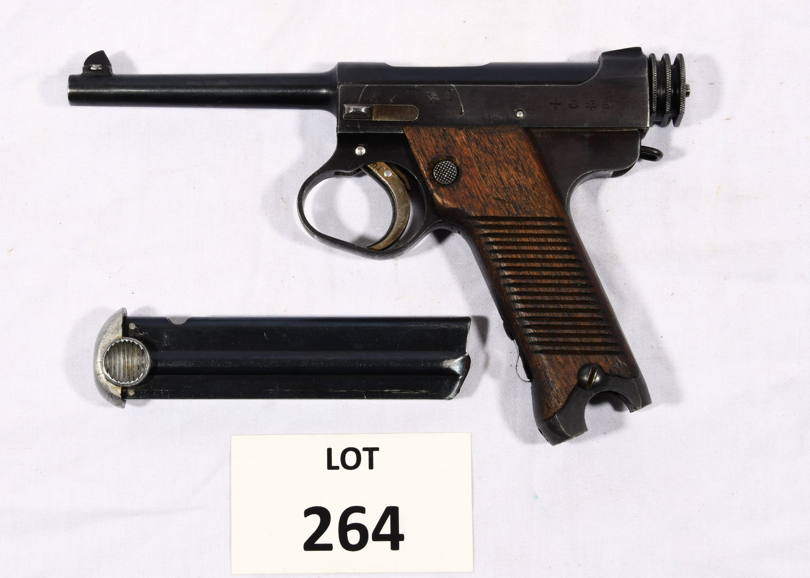 Japanese Nambu Pistol: A Japanese Nambu type 14 pistol made by Nagoya Arsenal in February of 1943. 8x22mm caliber (8mm Nambu). This pistol is in very fine condition with approximately 80% finish remaining. Wood grips are so