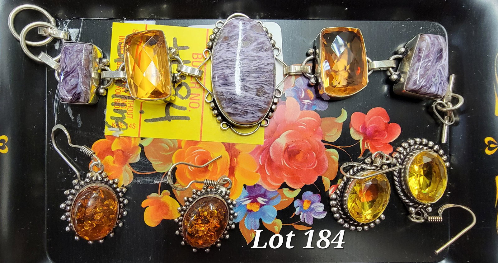 Sterling Silver Earring and Bracelet Lot: A bracelet and earring group with sterling silver settings. Bracelet features charoite and imperial topaz stones. Earrings have amber and citrine stones.