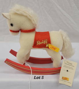 Steiff Mohair Rocking Horse: A Steiff white rocking horse toy made of genuine mohair. This toy has a red felt bridle and saddle blanket and red wooden rockers. Made in 2002. Original tags still attached. EAN 666803. 7"x7"x2 1/4".