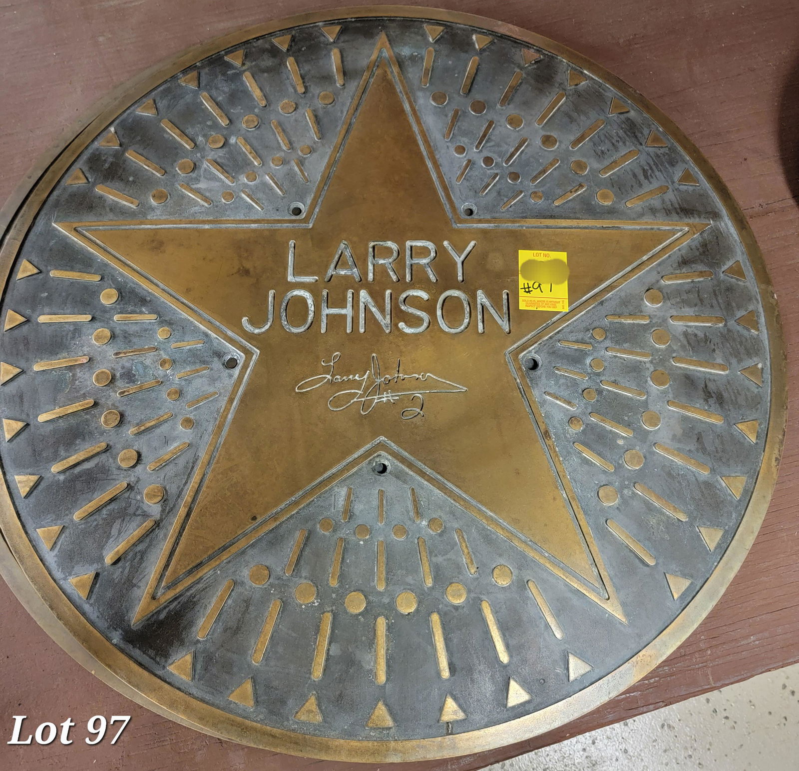 Sport sidewalk plaque for Larry Johnson: Large round bronze circular sports sidewalk plaque for New York Knicks forward, Larry Johnson. 2 ft across.