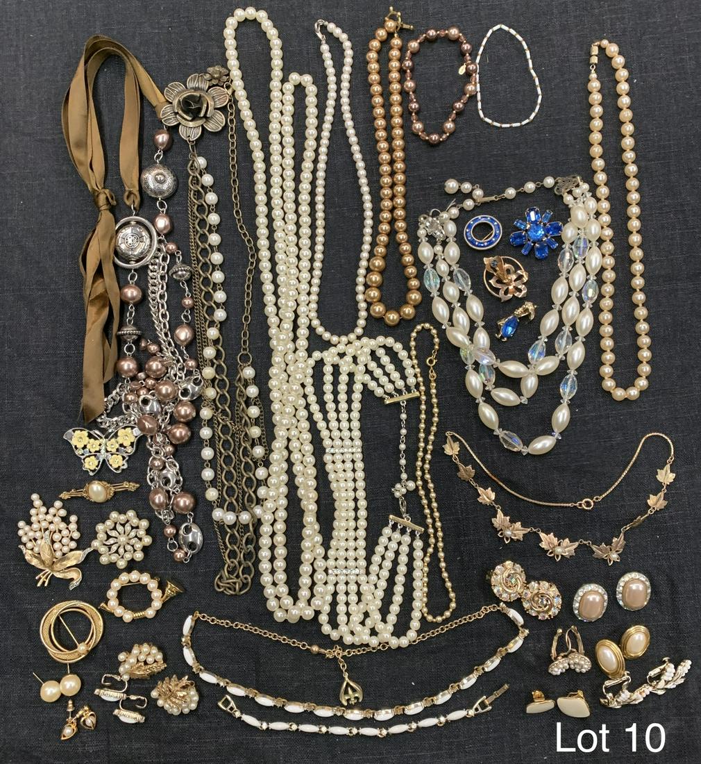 Lot of Costume Jewelry With A Focus On Pearls: An elegant lot of costume jewelry with a focus on pearl style beaded items. Several gold toned brooches, earrings, necklaces and bracelets with pearl beaded accents. A variety of neutral tones with a 