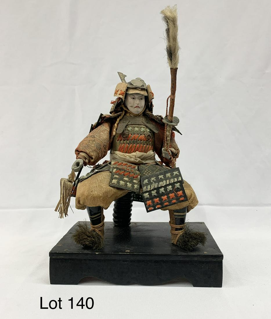 Antique Japanese Samurai Figure: An antique Japanese Samurai figure mounted on a wood base. 8 1/2"x 6 1/2"x 4 1/2". *notes- some wear from age. Base has some chips on it.