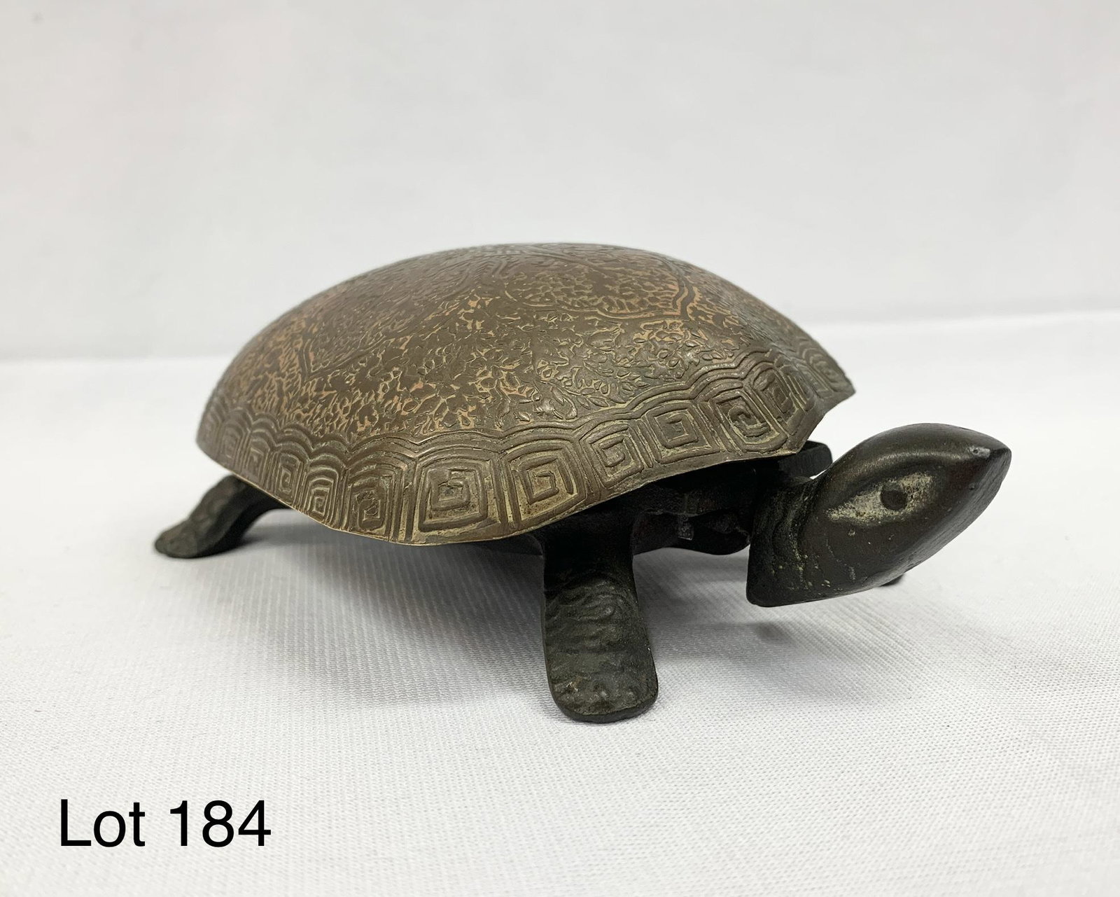 Cast Iron and Bronze Turtle Bell: A vintage cast iron and bronze turtle bell. It measures 7 1/2" x 2" x 4". *notes- missing one post on underside and spring is broken on bell.