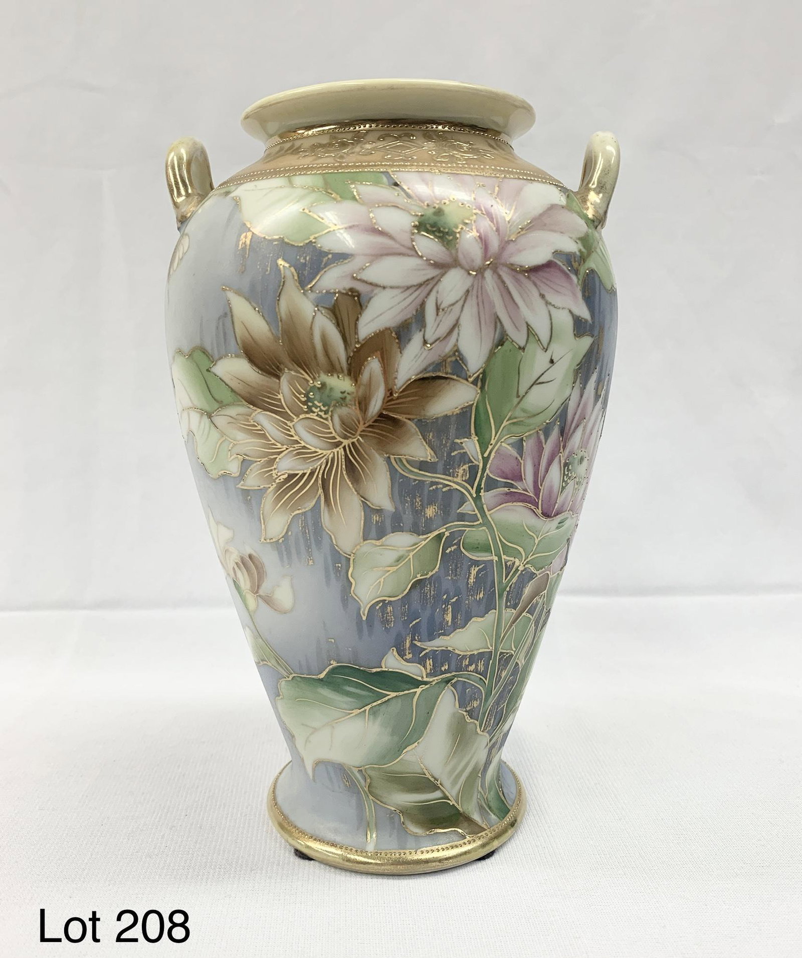 Antique Hand Painted Nippon Urn Vase: A beautiful antique urn vase by Nippon with hand painted floral decoration in muted tones. Gold toned accents throughout. This vase stands 8 1/4" tall. The underside is marked "Hand painted, Nippon". 
