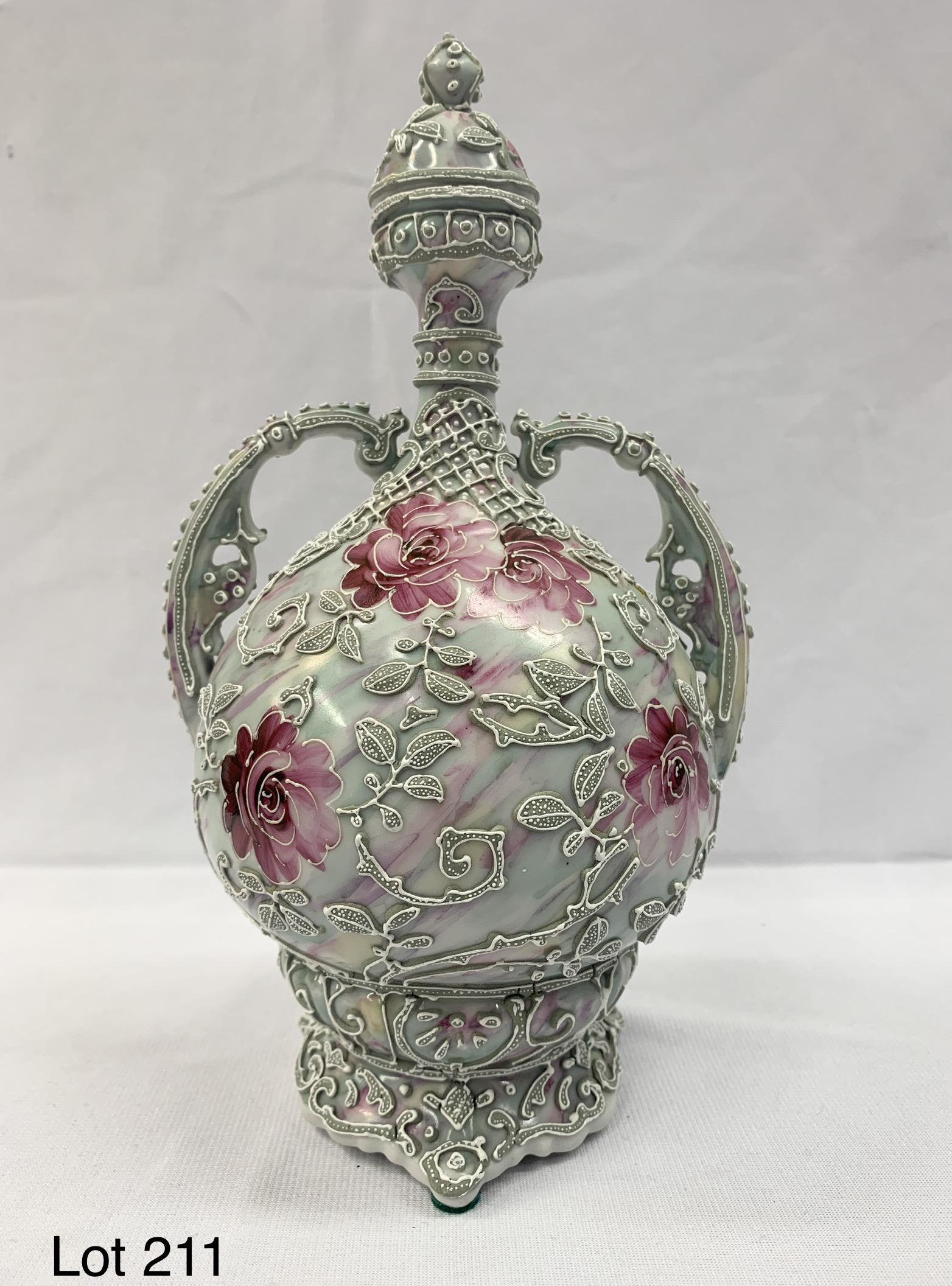 Antique Nippon Moriage Porcelain Vase With Stopper: An antique Japanese Nippon moriage porcelain bottle vase with lid. This vase is a light sage green with beautiful hand painted floral decoration. It has curved handles on each side. Measurements are 9