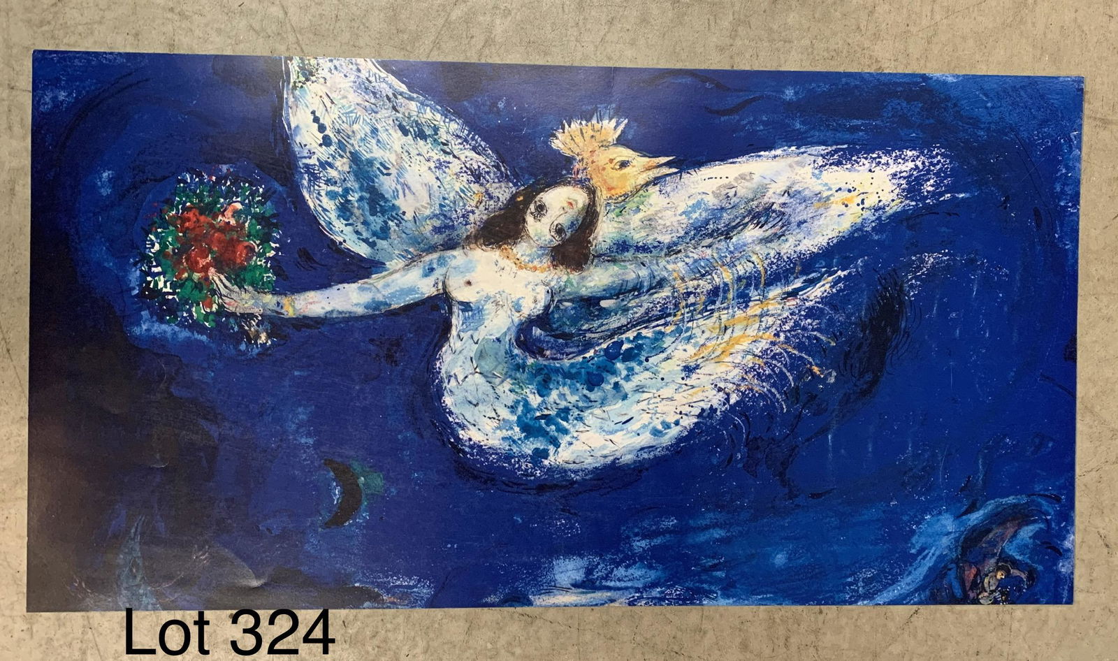 Marc Chagall Offset Lithograph: An offset lithograph of "The Firebird" by Russian born French artist Marc Chagall (1887-1985). This piece depicts a floating angel holding a boutique of roses against a dark blue night sky. It measure