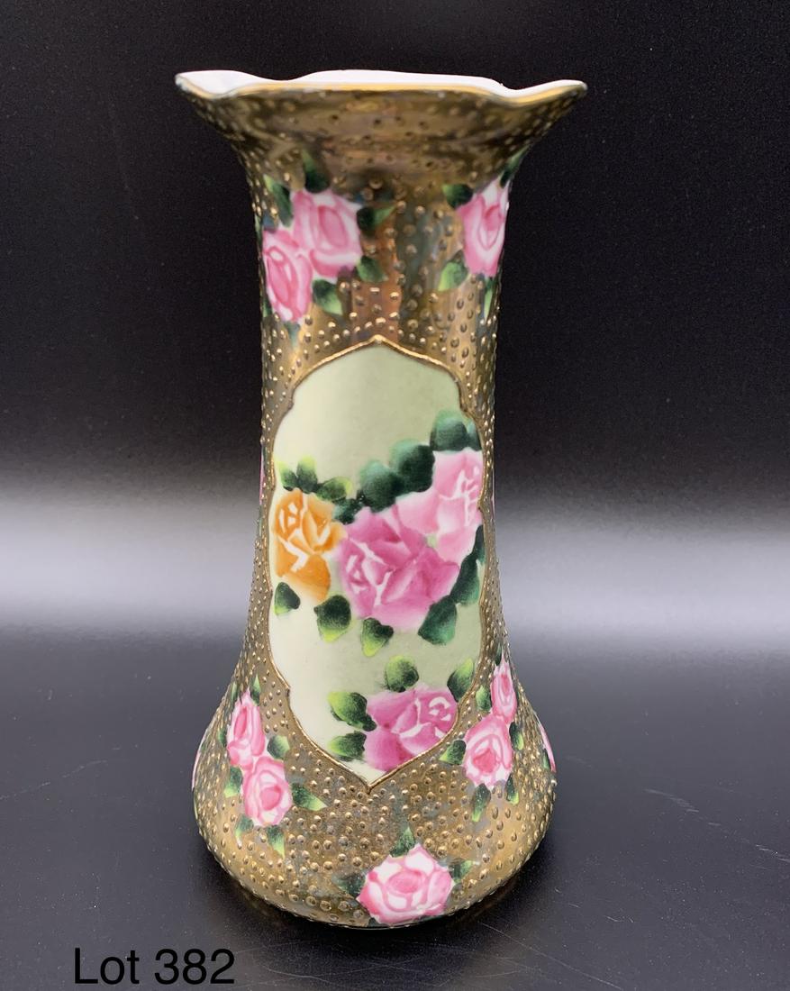 Vintage Nippon Porcelain Hat Pin Holder: A vintage porcelain Nippon hat pin holder with floral design and gold toned detailing. It stands 6" tall.