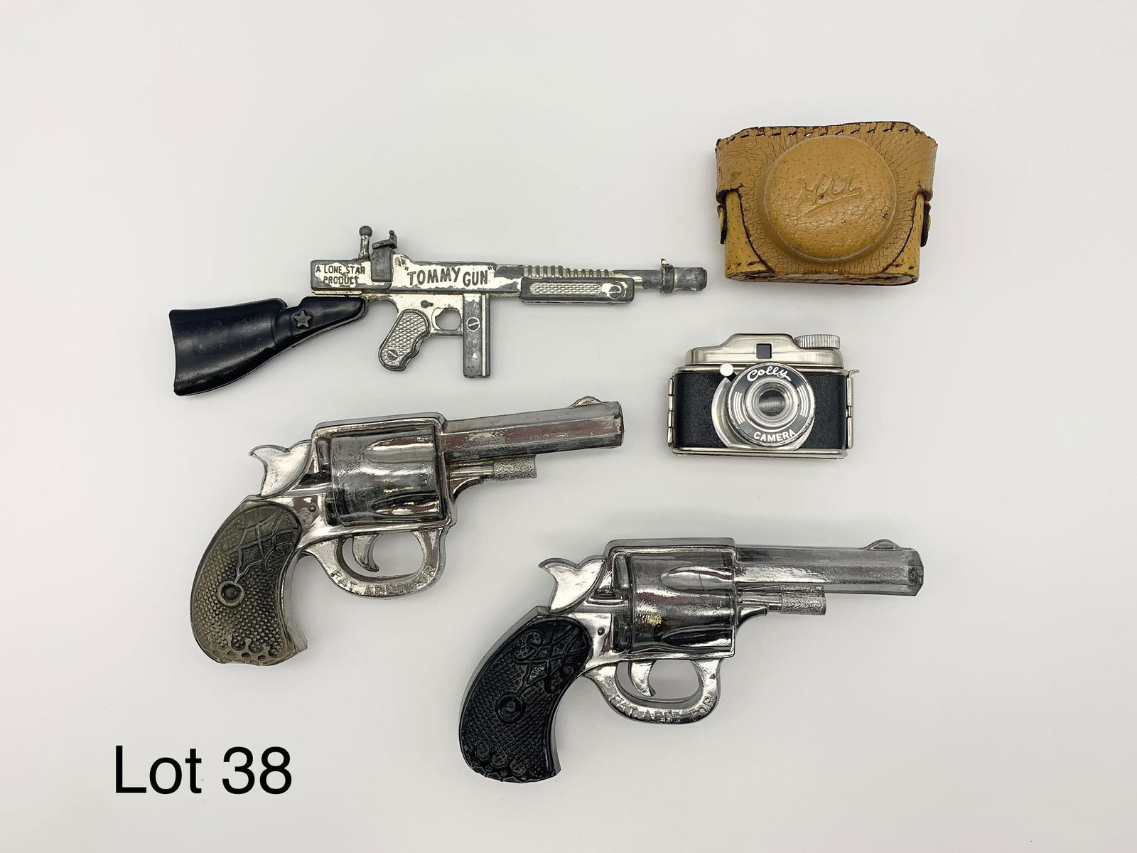 Lot of Vintage Miniature Toys Including Camera and Guns: Colly camera, Lone Star Products "Tommy Gun" and two clear acrylic? toy guns. Camera is 2" long, Tommy Gun is 6 1/2".