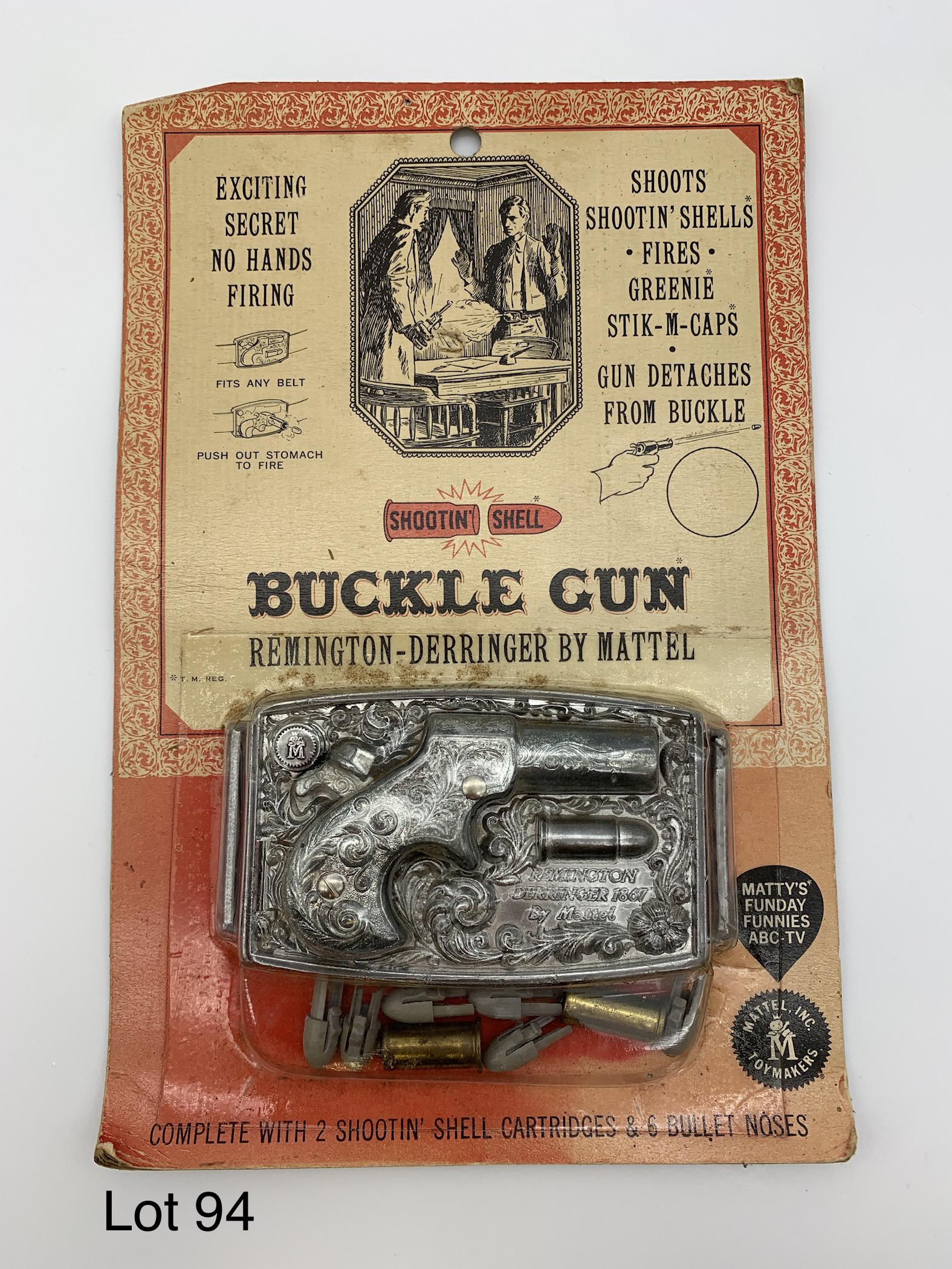 Vintage 1959 Shootin' Shell Buckle Gun In Original Packaging: A vintage 1959 Shootin' Shell Remington-Derringer buckle gun by Mattel. Includes 2 shell cartridges and 6 bullet noses. In original packaging. Dimensions are 9" x 6".
