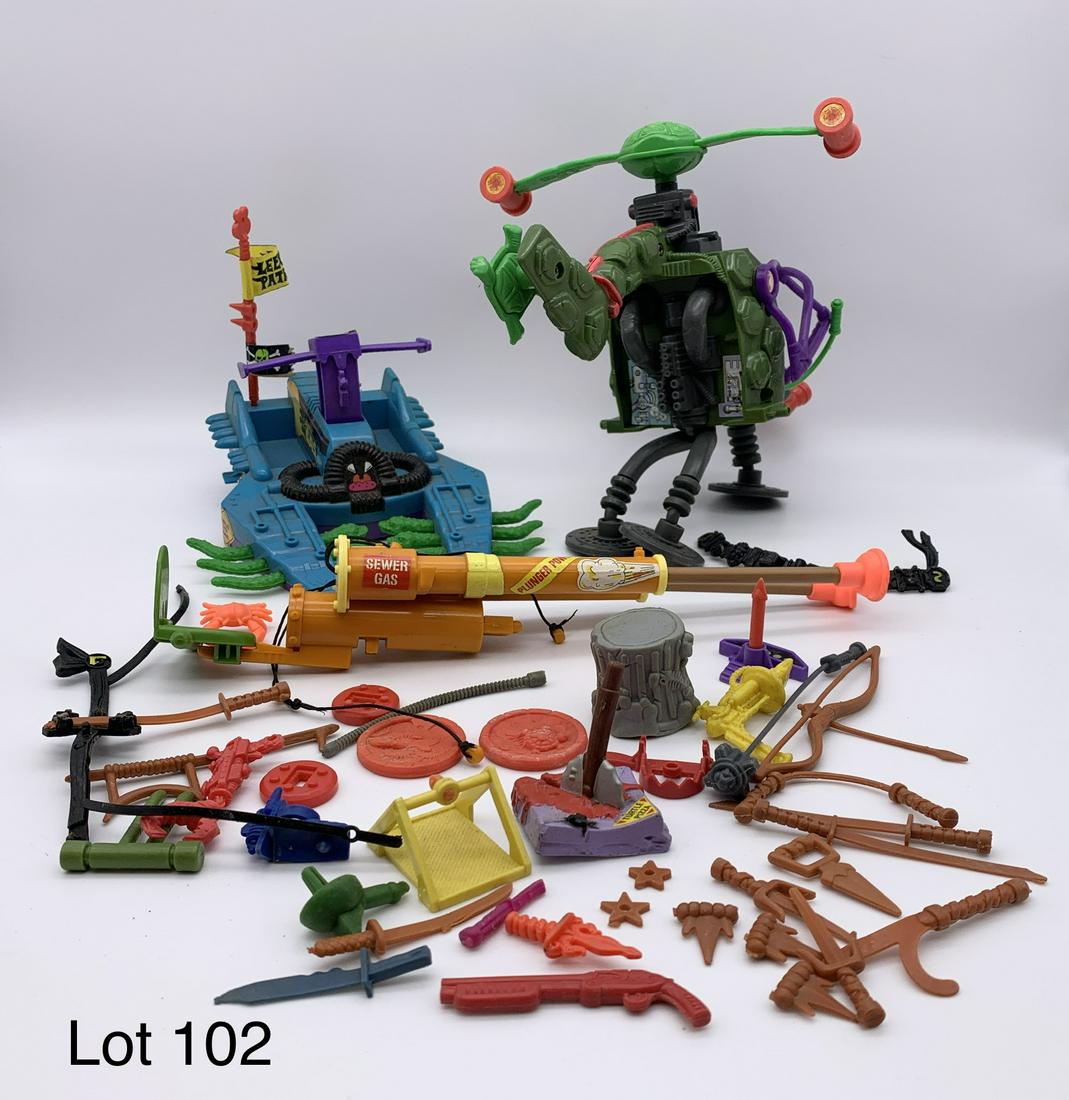 Lot of Vintage 80's-90's Teenage Mutant Ninja Turtle Accessories: A lot of vintage late 1980's to early 1990's Teenage Mutant Ninja Turtles vehicles, weapons and accessories. Includes the rare Footski vehicle, a double barreled plunger gun and Rocksteady's Pogocopte
