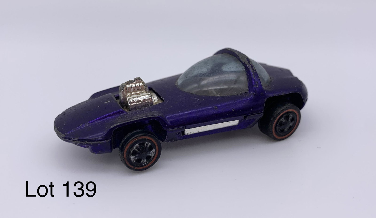 Vintage Hot Wheels 1967 Silhouette Redline Car: A vintage Hot Wheels 1967 purple Silhouette redline car with open engine. The bottom of the car is marked "Hot Wheels Silhouette 1967 Mattel Inc. USA US and Foreign Pat. Pending". *notes- car has wear