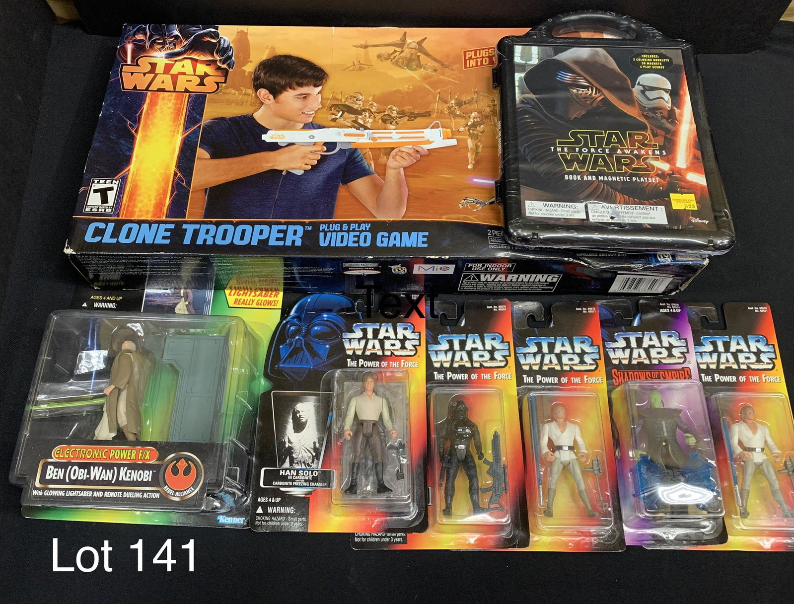 Collection of Star Wars Toys: A collection of Star Wars toys including Clone Trooper Plug & Play Video Game, a Star Wars: The Force Awakens book and magnetic play set and six Star Wars action figures. Action figures featured are O