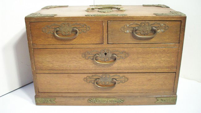 VINTAGE JEWELRY BOX: 15" x 10" x 8", Wood construction with brass pulls and highlights, The four drawers are blue felt lined. Some discoloration on metal and some scuffs from use. The middle drawer has a lock , but withou