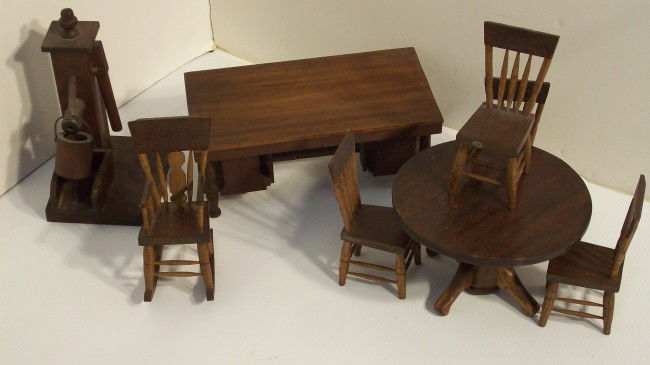 FOLK ART HANDMADE MINIATURE FURNITURE: Round Table 6 1/4" X 3 1/2" tall, octagonal base four legged, with four chairs. Rocking chair 5" tall X 2 1/4" wide X 4" glides. Partner's desk 8 3/4" X 4 3/4" x 3 1/2" tall, made from a cigar box. Wa
