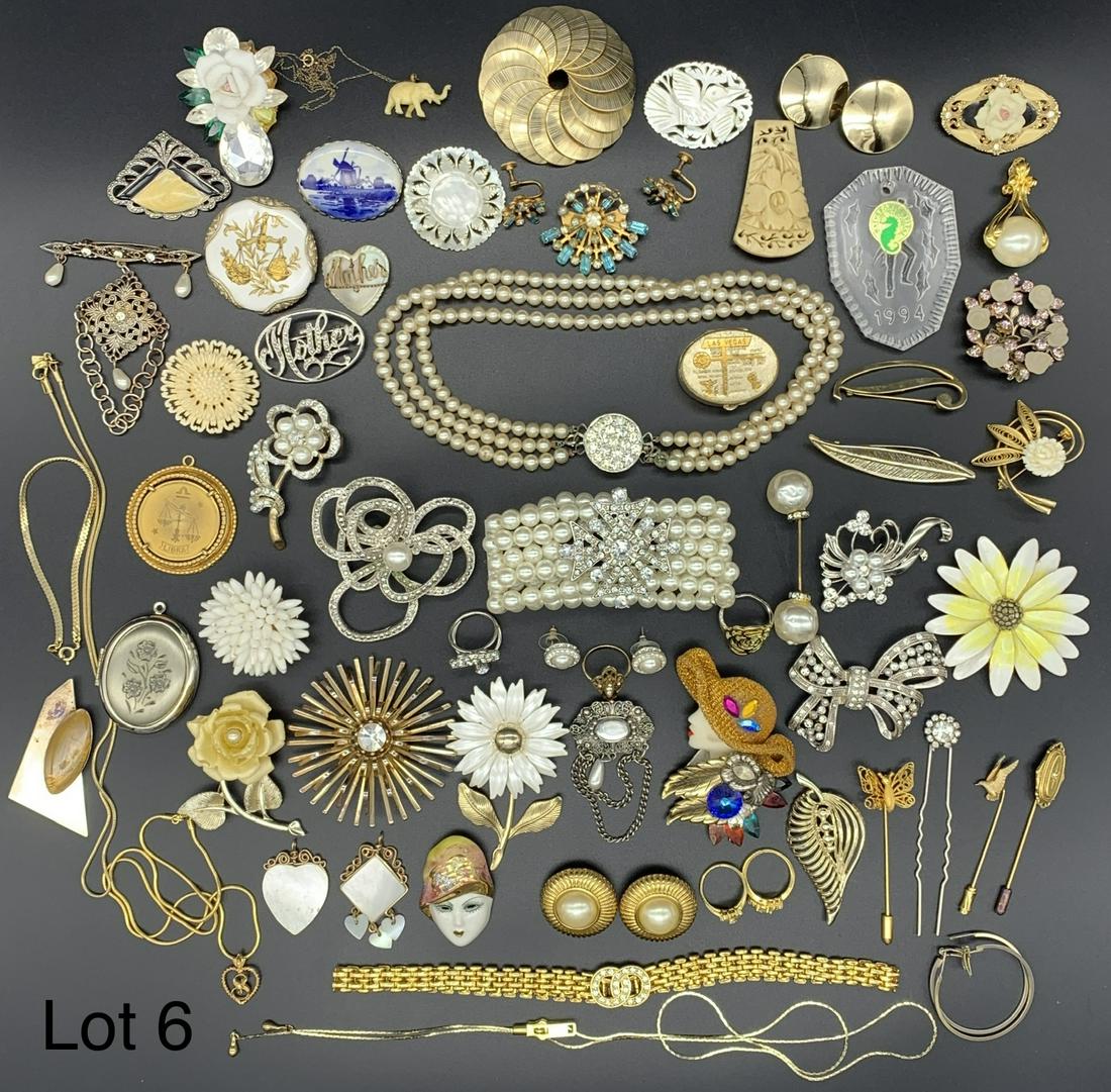 Collection of Costume Jewelry Including Brooches: A nice selection of costume jewelry brooches including mother of pearl, faux pearl and more. Of note is a Waterford Crystal pendant and a delft brooch. A great group of items perfect for Mother's Day 