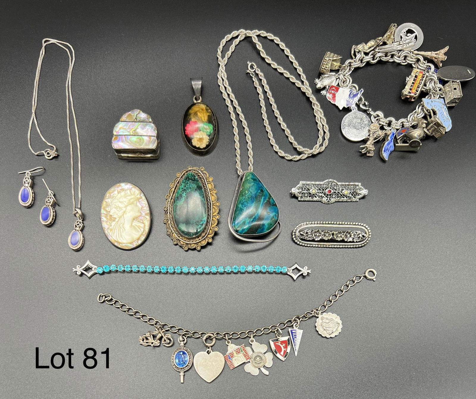 Sterling Silver Jewelry Collection: A unique selection of sterling silver jewelry. Includes a pendant necklace and earring set with blue stones, brooches, charm bracelets, a bracelet with teal stones, an abalone shell pill box and more.