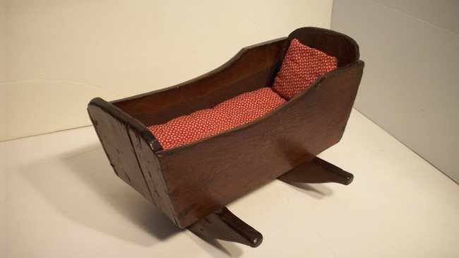 Early 19th Century Doll Cradle: 14 1/2" long X 8' tall X 10 3/4" wide, wood advertizing crate construction, a push sets in motion for some time, excellent early piece