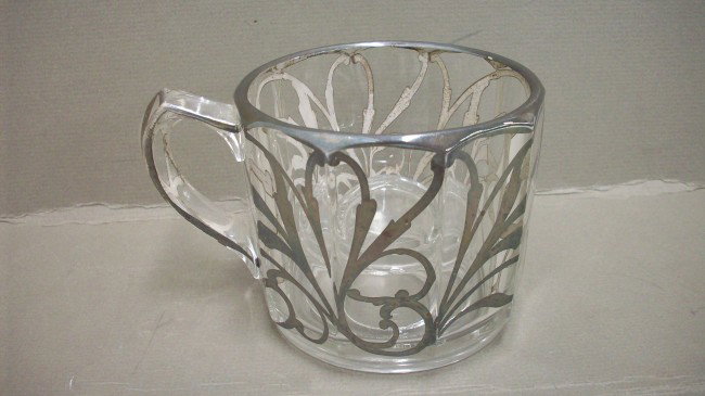 Shaving Cup with Silver Overlay: 3 1/4' tall X 4" across (not including the handle), Marked on the bottom: J. Handel Pat Feb 9, 1909 No 911873, manufacturing defect on soap holder, inlay intact, excellent condition