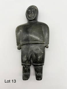 Canadian Inuit Carving: A Canadian Inuit carving of grey/green soapstone depicting a man in traditional garb. 7 1/2" tall.