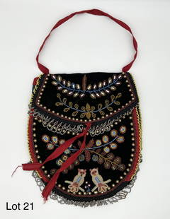 Iroquois Beadwork Carrying Bag: An outstanding example of modern (ca. 1950's) Iroquois beadwork. This large carrying bag is decorated profusely with foliate elements, owl images, cats and tasseled rosettes. 11" x 9 1/2".