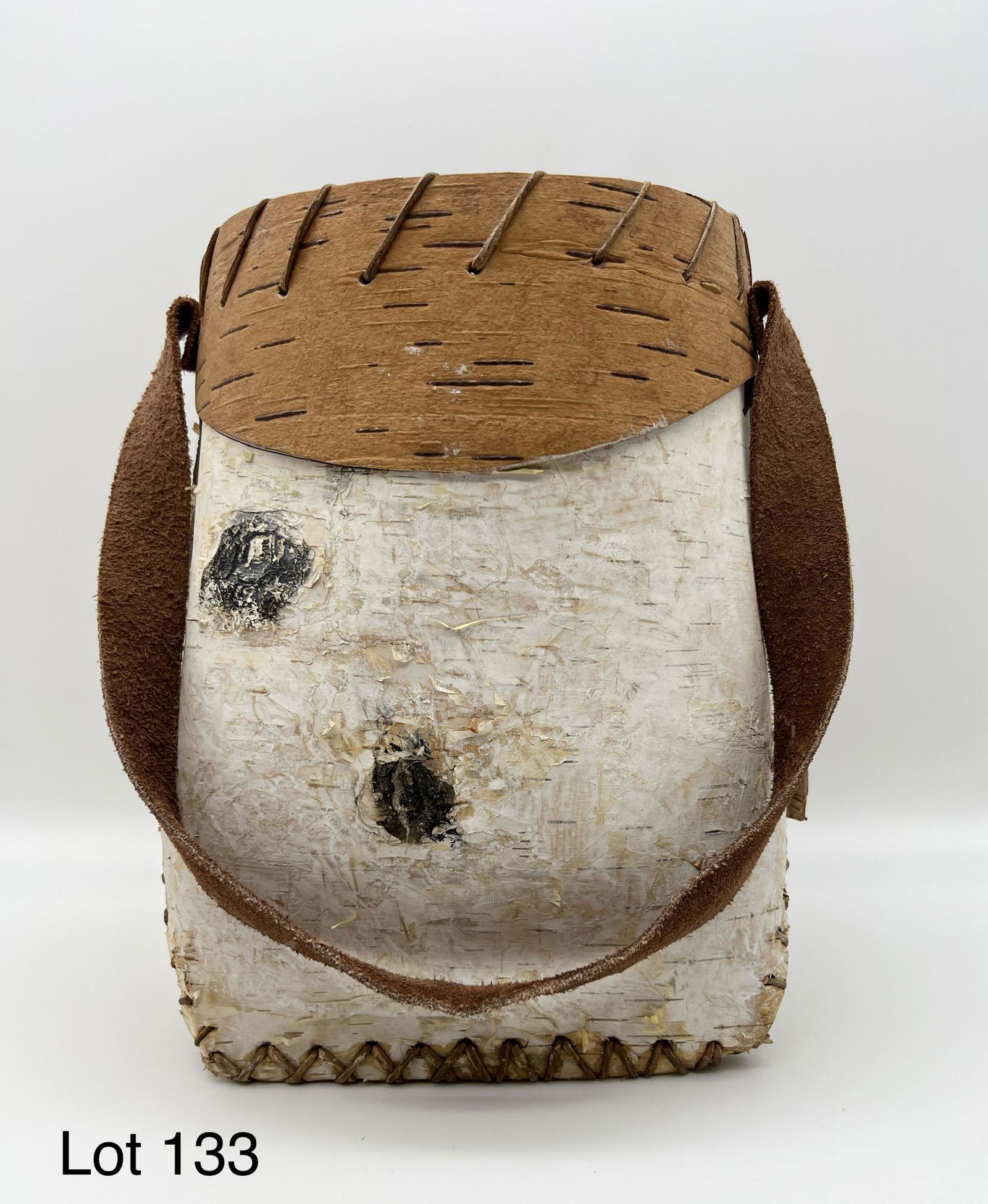 Canadian Indian Birch Bark Bucket: A Canadian Indian birch bark bucket with a leather strap handle. 9" tall.
