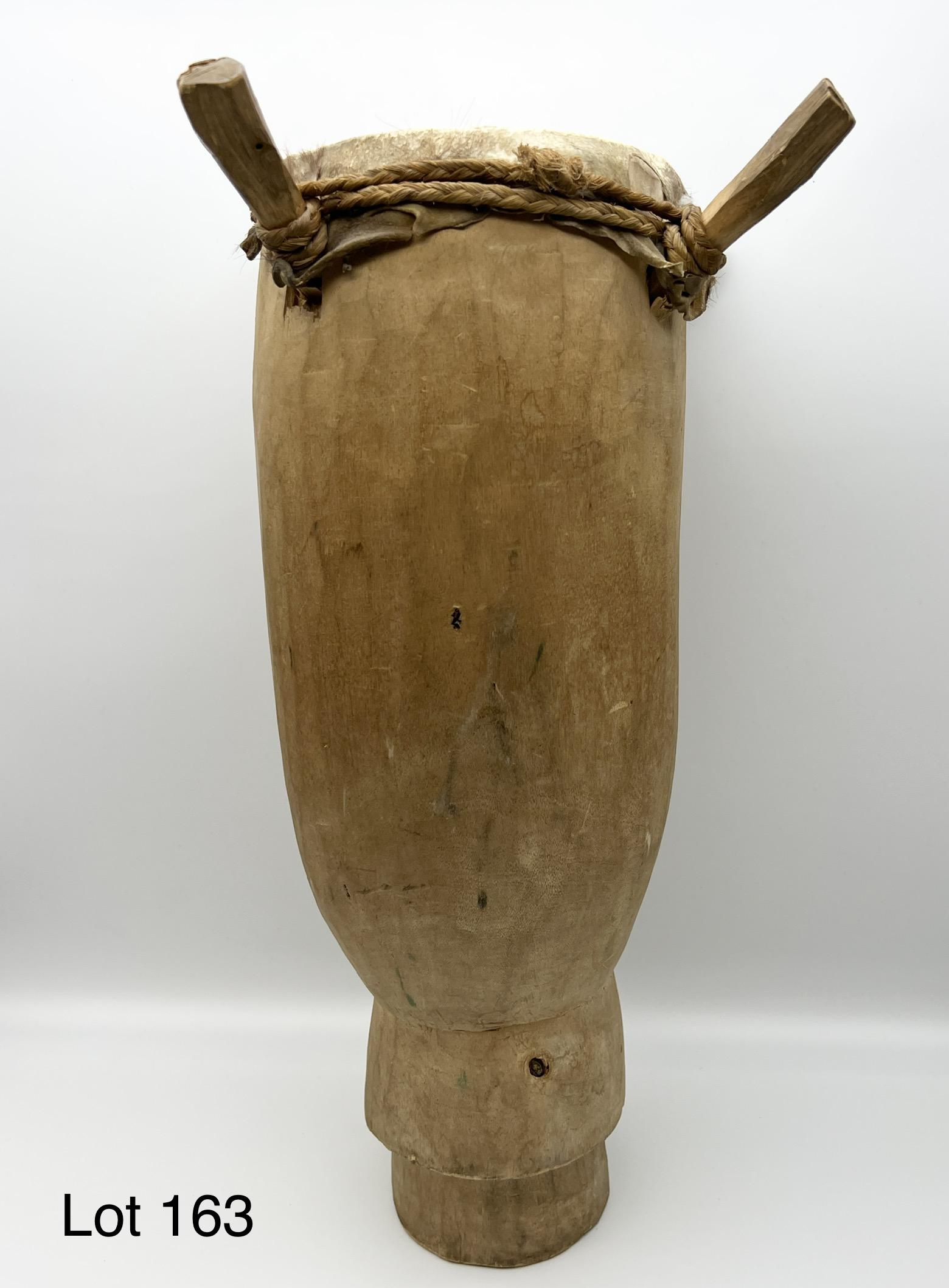 Primitive Wood and Goat Skin Drum: A primitive wood and goat skin drum. Hand-hewn with pegged top. 15" tall.