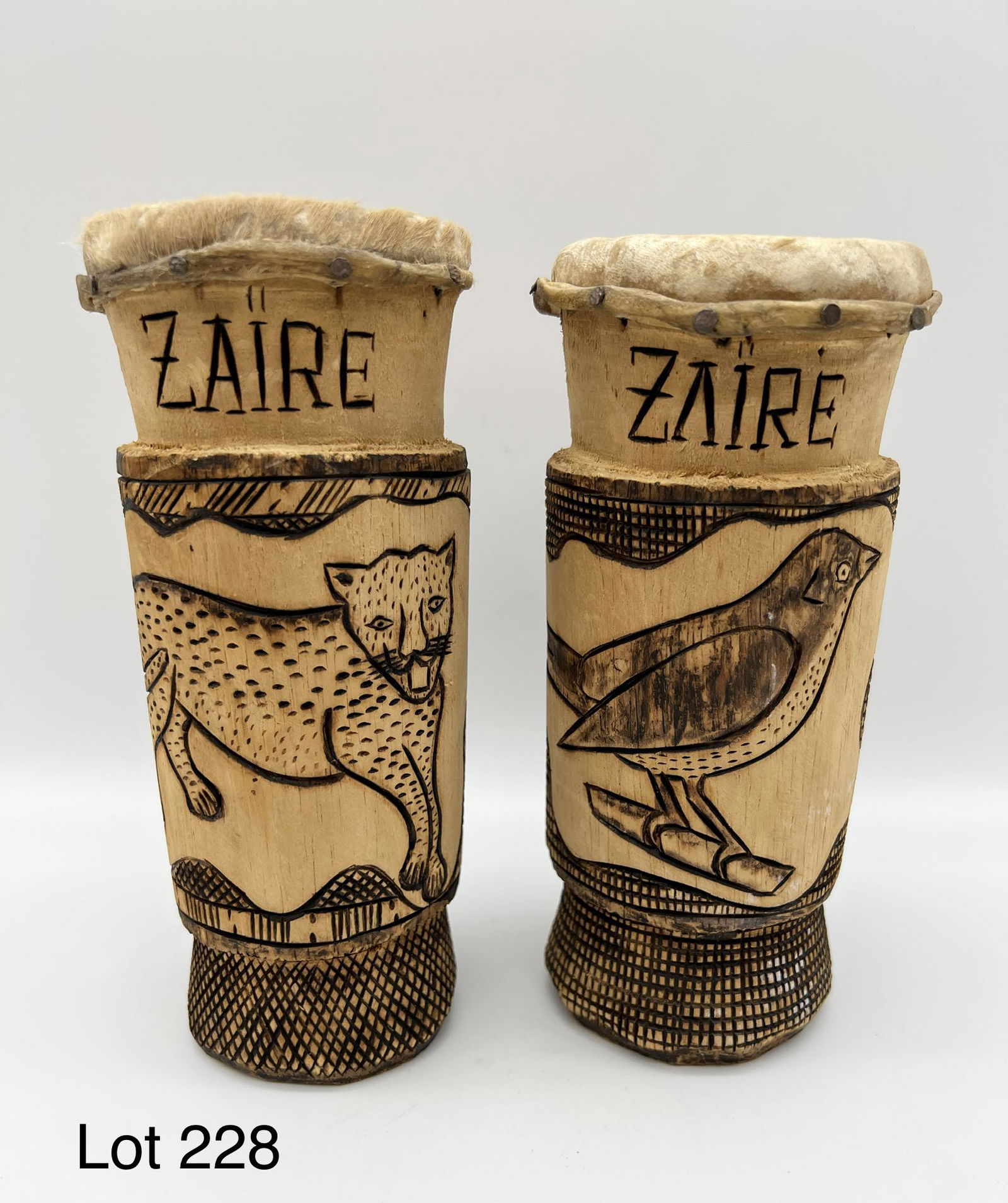 Lot of Small Carved Wood Drums: A pair of carved wood drums with cheetah and bird carved on the body. Marked "Zaire" at the top. Each drum is 7" tall.