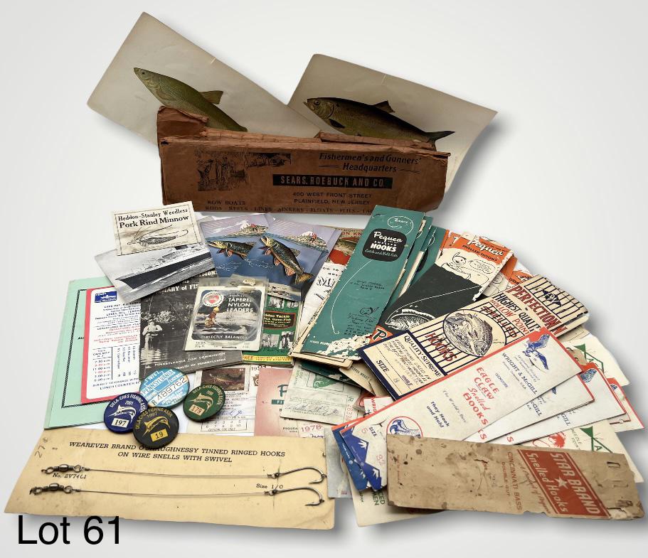 Assorted Vintage Fishing Ephemera: An assorted collection of vintage fishing ephemera including fishing license buttons, snelled hook packs and two fish lithographs.