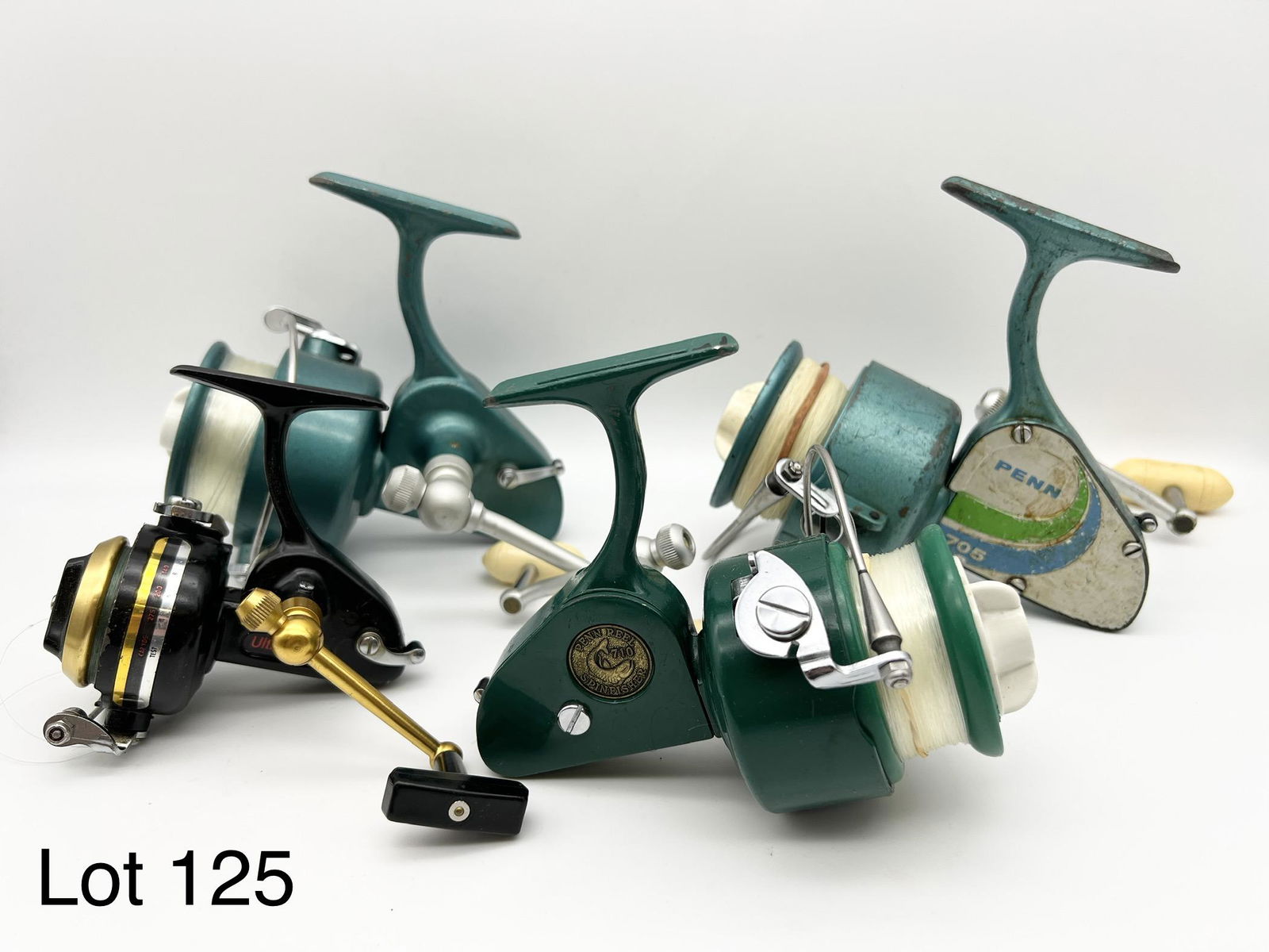 Lot of Vintage Penn Spinfisher Reels: Lot of four vintage Penn Spinfisher reels, one 704, one 705, one 710, and one 714Z. All in very good to excellent condition, though the medallion has detached from the side plate of the 704