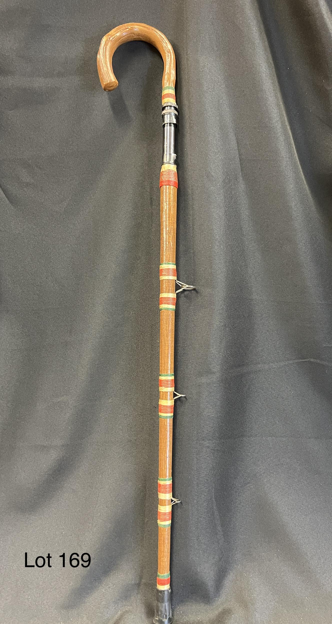 Fishing Rod Walking Stick: A whimsical fishing rod walking stick / cane. Measures 35" long, with three carbide guides and a metal reel seat.