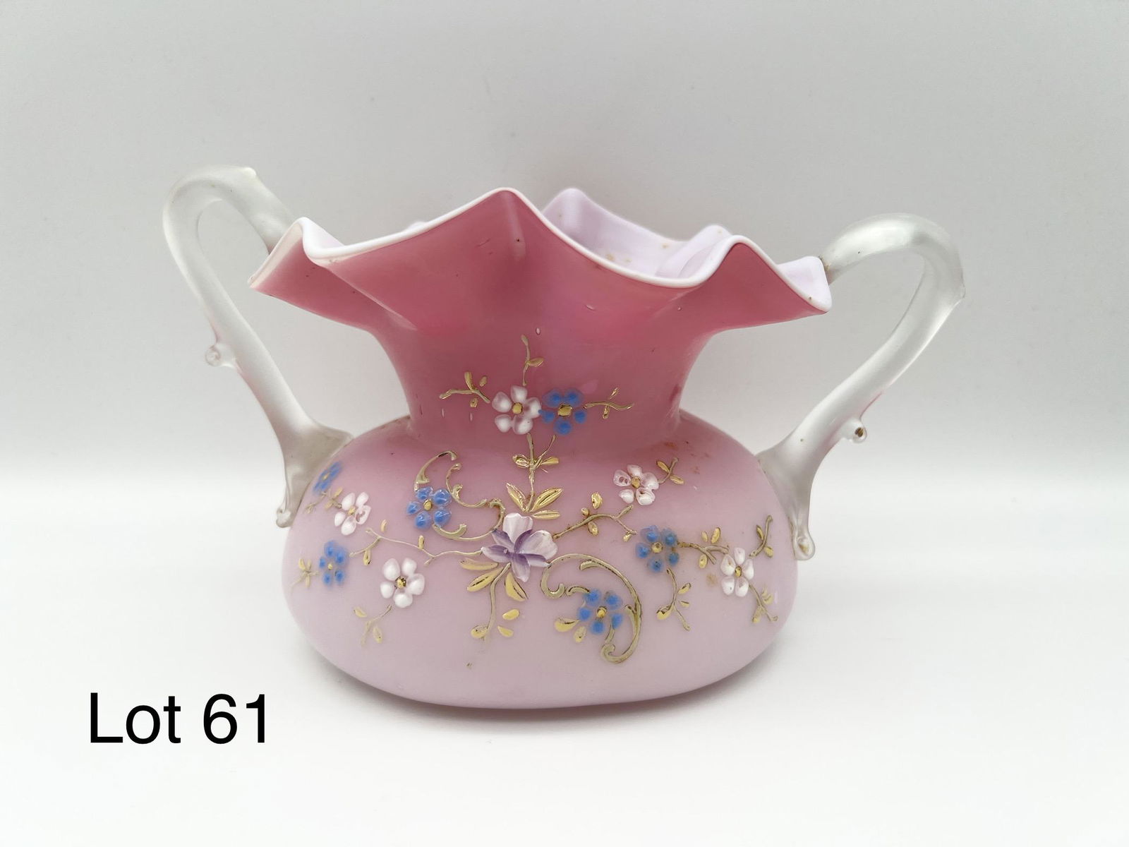 Cased Pink Satin Glass Vase: A cased pink satin glass vase with blue and white enameled floral design and double camphor thorn handles. Possibly a Thomas Webb vase. Measures 5" x 3 1/2".4 1/2".