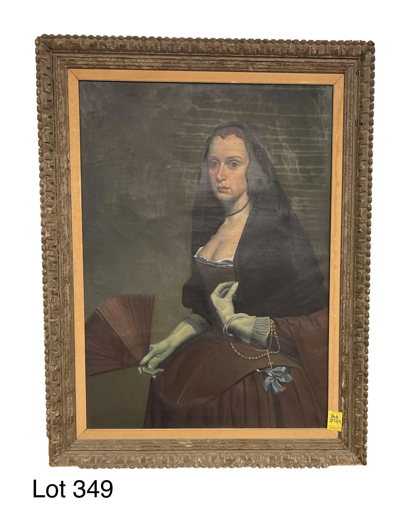 Antique Oil on Canvas of Hooded Woman: Antique oil on canvas of a hooded woman, holding a fan and a string of beads (rosary?). Wooden ridged frame has some damage, with some of the teeth missing around the edges. Fabric lining is present o