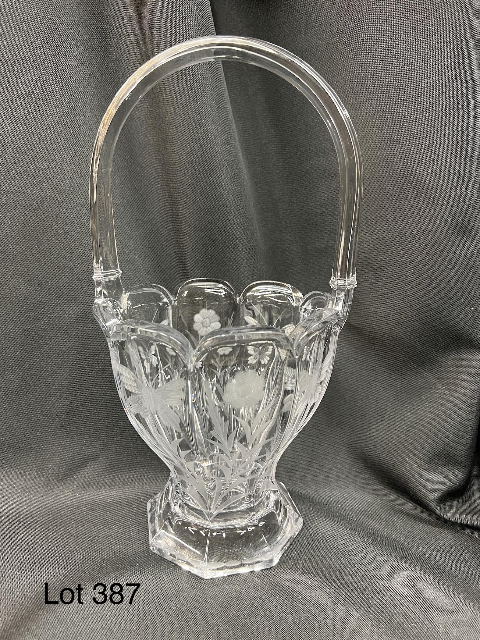 Vintage Heisey Glass Flower Basket: Vintage Heisey glass flower basket in colonial style. Floral motif etching around the sides, makers mark on underside. Measures 13 1/2" tall.