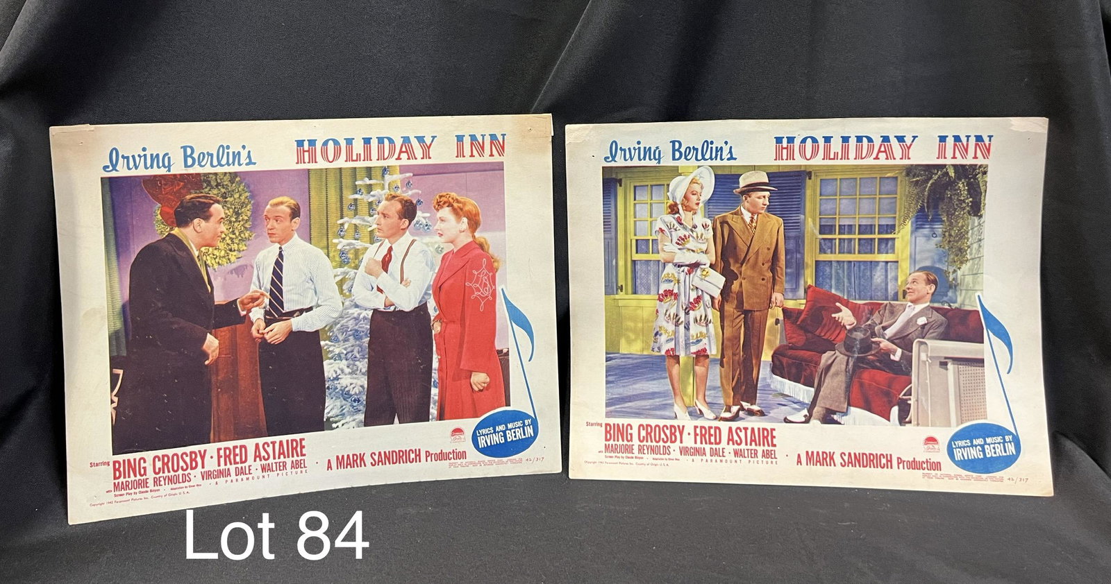 Lot of Vintage Holiday Inn Lobby Cards: Lot of two lobby cards from the 1942 film Holiday Inn, starring Bing Crosby and Fred Astaire, with music by Irving Berlin. Both cards numbered 42/317, holes noted in corners where previously hung up, 