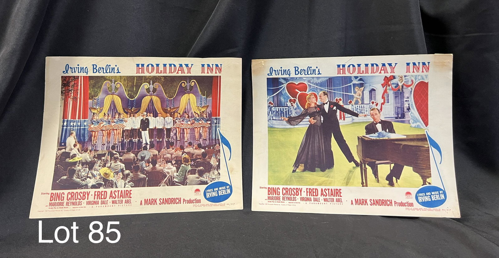 Lot of Vintage Holiday Inn Lobby Cards: Lot of two lobby cards from the 1942 film Holiday Inn, starring Bing Crosby and Fred Astaire, with music by Irving Berlin. Both cards numbered 42/317, some staining and discoloration with age noted, o