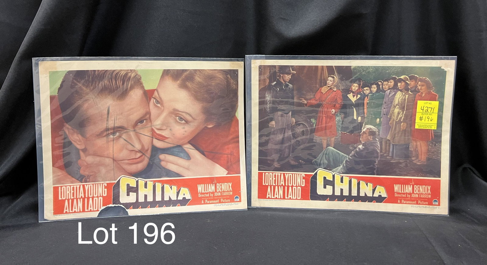 Lot of Vintage Lobby Cards for China: A lot of 2 vintage lobby cards from the 1943 film China starring Loretta Young, Alan Ladd and William Bendix. Directed by John Farrow. Cards measure 14" x 11". *notes- Wear from age. Hole on corners. 