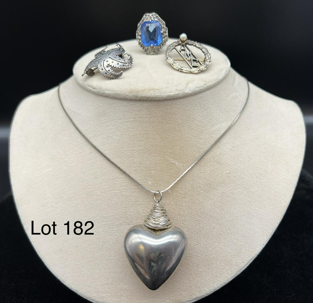 Lot of Creative Sterling Silver Jewelry: Lot of fun and creative sterling silver jewelry including a heart necklace, a starfish pin, an AMC pin, and a man made sapphire/marcasite ring (Size 5). Weighs 0.955 Troy Ounces.