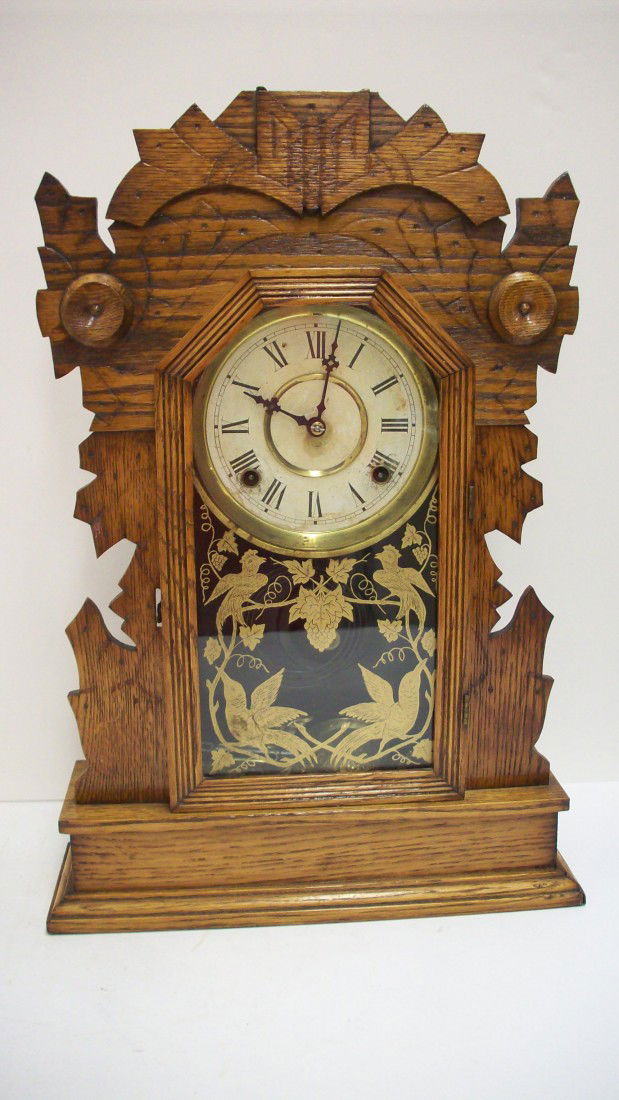 Oak Gingerbread Clock: 20 3/8" X 14" X 4 1/4", Probably a Seth Thomas sold by Augustus Rhoads, a dealer in watches, clocks and silver, at 20 E. King St Lancaster, PA. circa 1890's, clock is complete, Excellent working condi