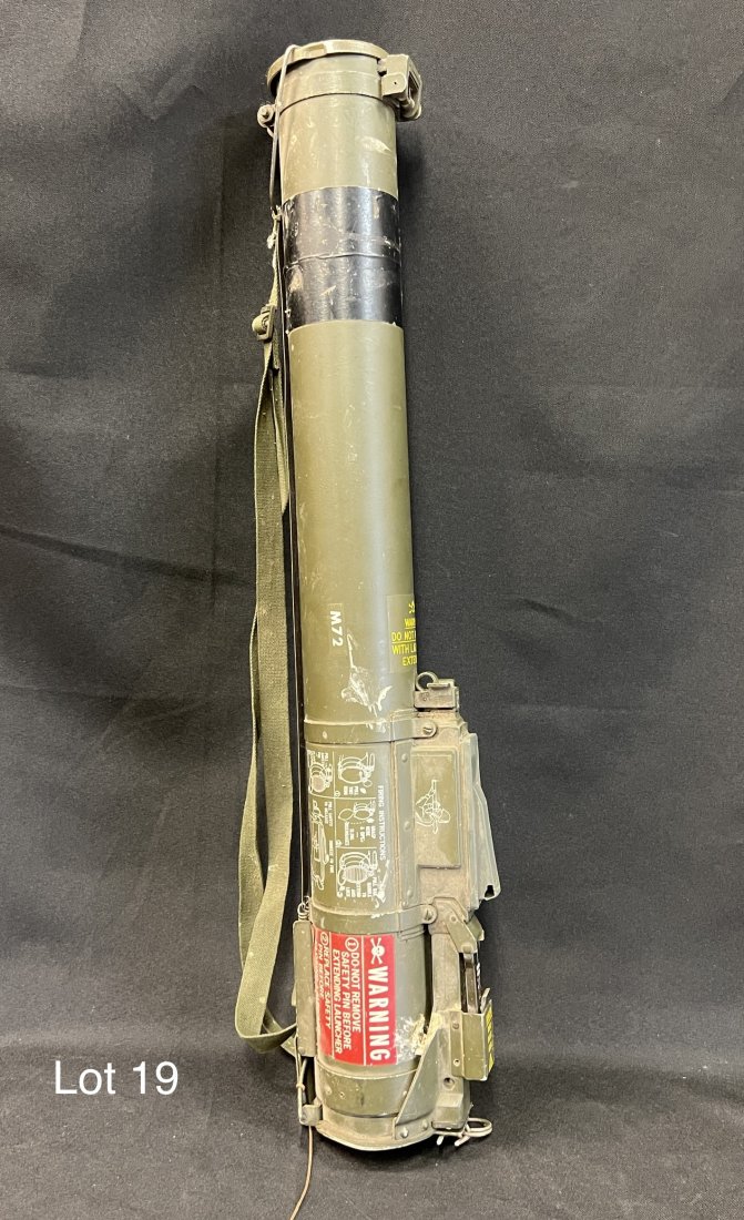 Inert U.S. Army M72 LAW 66mm: Inert U.S. Army issue M72 LAW 66mm rocket launcher, loaded with a dummy fuse. Piece features all original markings and strap, including instructions on operation. Measures 25" long. *note - wear and s