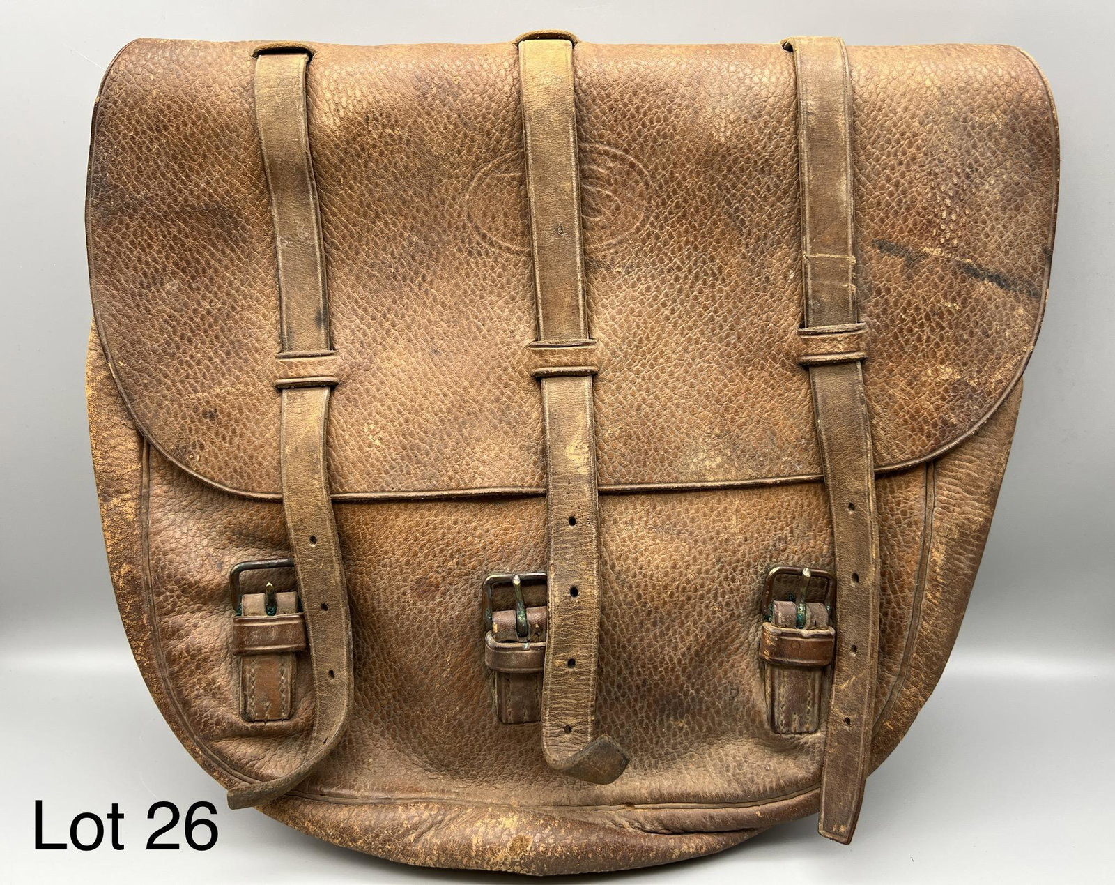 U.S. Turn of the Century Leather Saddlebag: Turn of the century U.S. Army leather saddlebag, including original straps and buckles. Faded U.S. marking on front, measures 13 3/4" across. *note - wear with age