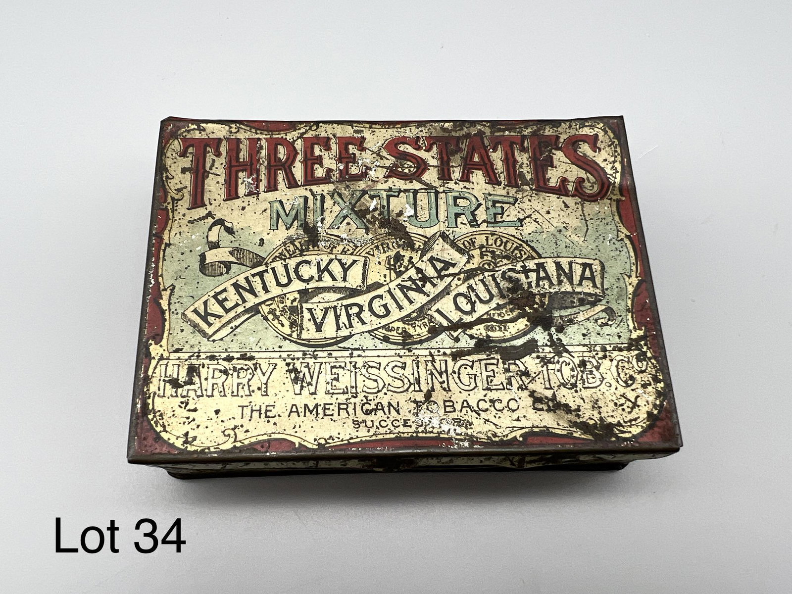Three States Mixture Tobacco Tin: Three States Mixture tobacco tin, from Kentucky, Virginia, and Louisiana. Produced by Harry Weissinger Tob. Co. Product info on underside, measures 4 1/2" x 3 1/4". *note - scratches and wear with age