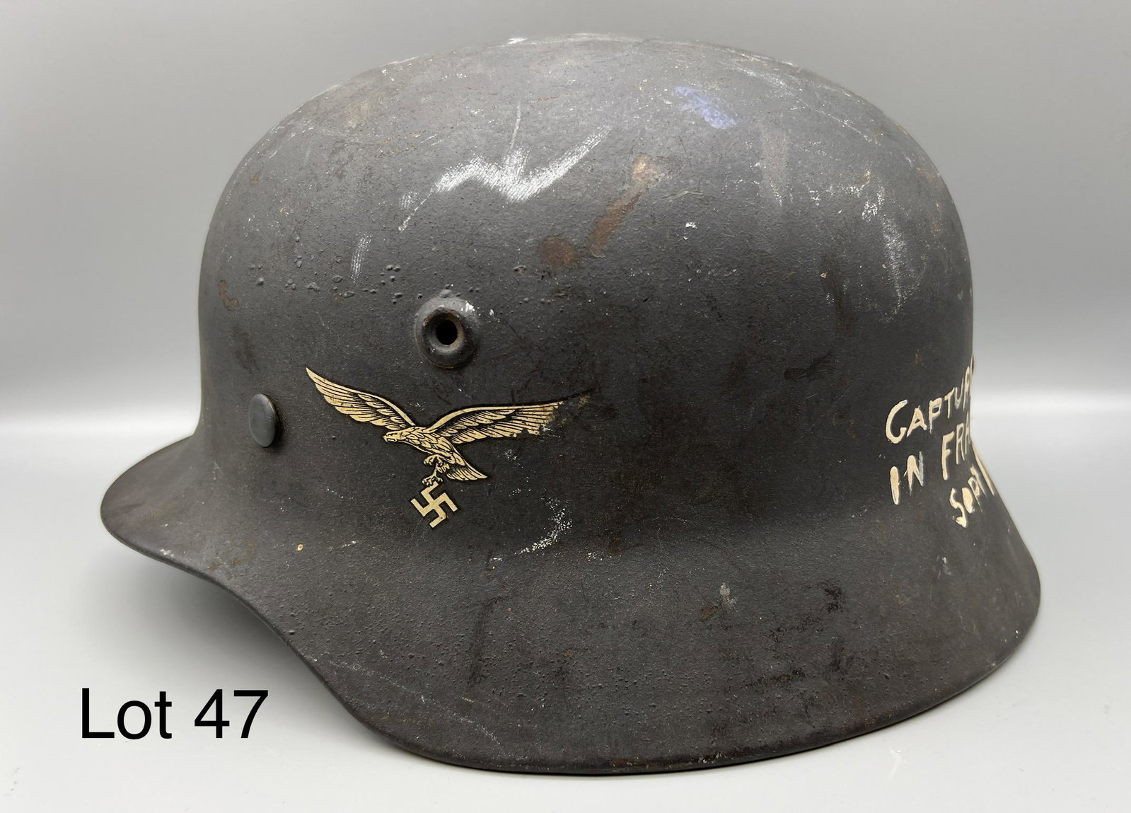 WWII German Luftwaffe Stahlhelm Helmet: WWII Stahlhelm helmet used by the German Luftwaffe, Luftwaffe decal on left side, noted in good condition. Piece has written "Captured in France Sept 1944" written on back. Measures 11 1/4" long, 6 1/