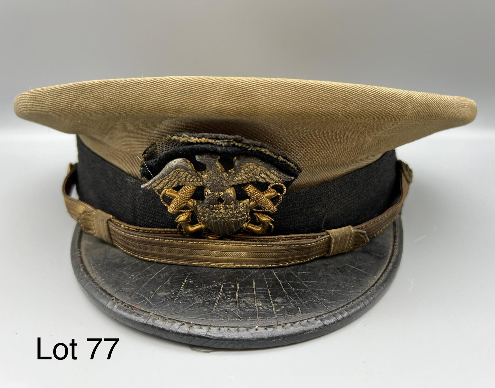 Vintage U.S. Navy Cap: Vintage regulation U.S. Navy Cap, makers marks and identification in inside of cap, along with tag to "Russell P. Bolton, M.D." Measures 11 1/2" long, 10 1/4" across. *notes - folded newspaper noted i