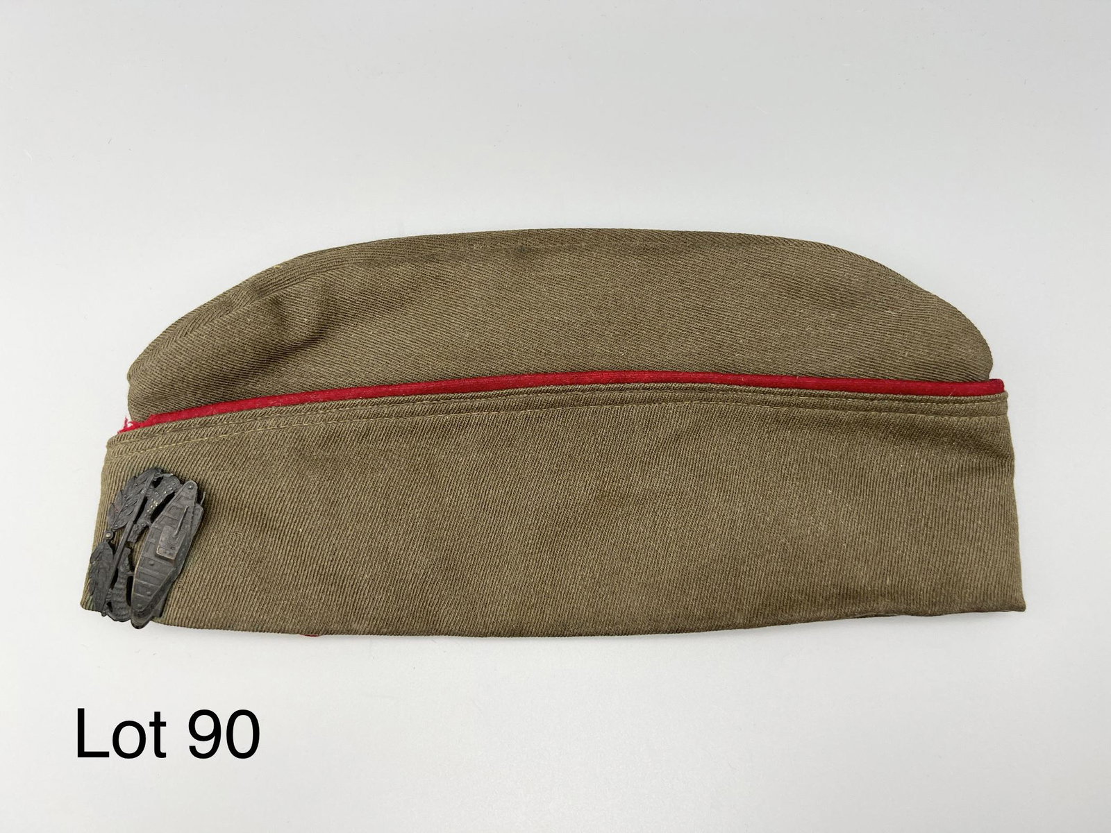 U.S. Army Garrison Hat with Tank Pin: WWII U.S. Army garrison hat with WWI brass tank division pin, all in excellent condition with leather interior lining. Measures 10 1/2" long, pin measures 1 3/4" across. *note - minor staining inside 
