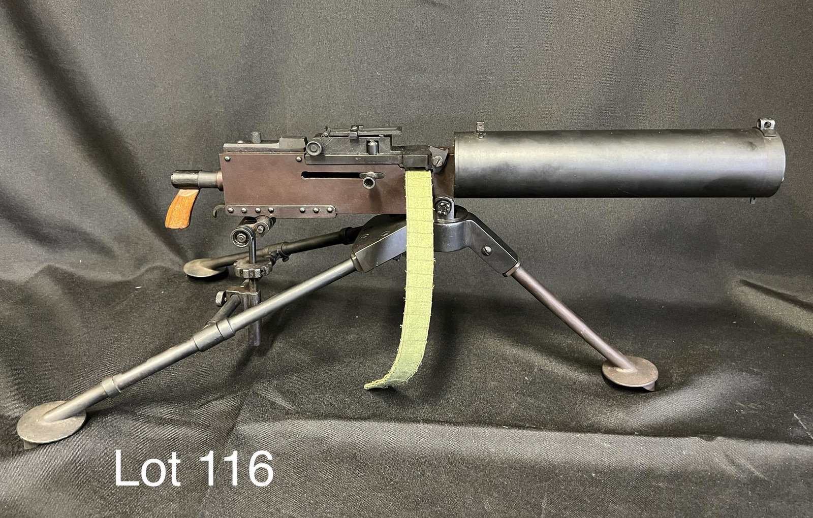 Scale Model Maxim Machine Gun: Scale model of a WWI Maxim machine gun. Barrel filled and capped with red dot, tripod fully functional and gun swivels. Gun measures 18 1/2", 21 1/2" total. *notes - minor patina and scratches